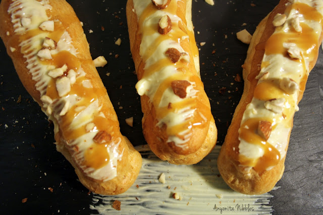 Anyonita Nibbles: a trio of white chocolate & maple caramel eclairs with orange & star anise cream & chipped almonds